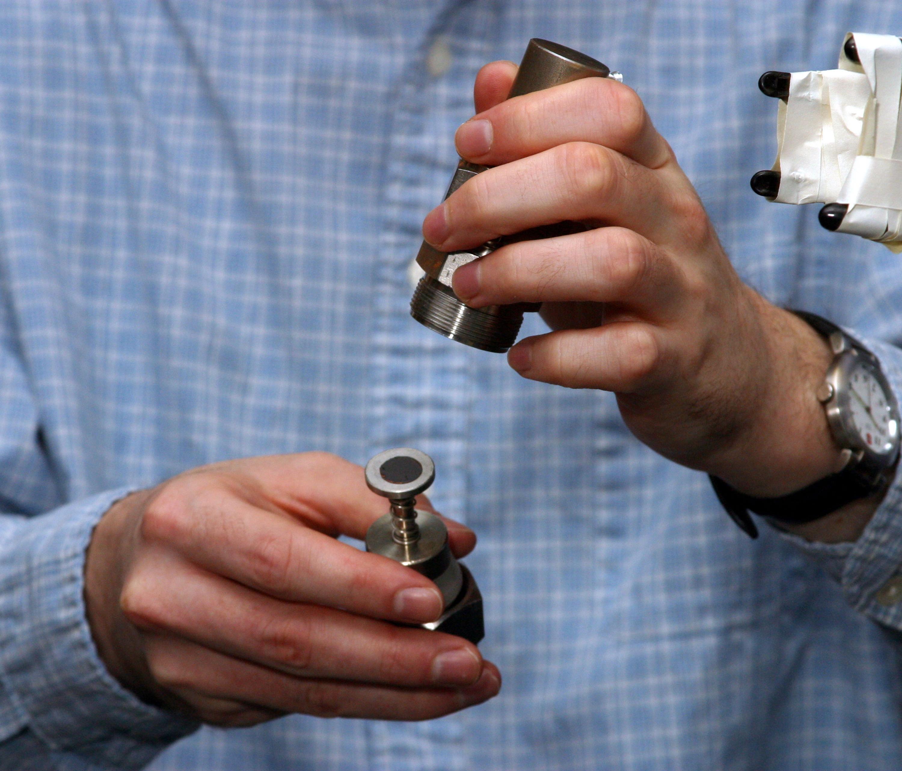 A researcher at Sandia National Laboratories assembling an electrochemical test cell with a silicon-graphite composite anode